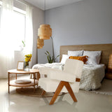 Witte POOLY loungestoel met houten poten in een lichte slaapkamer van hjh LIVING