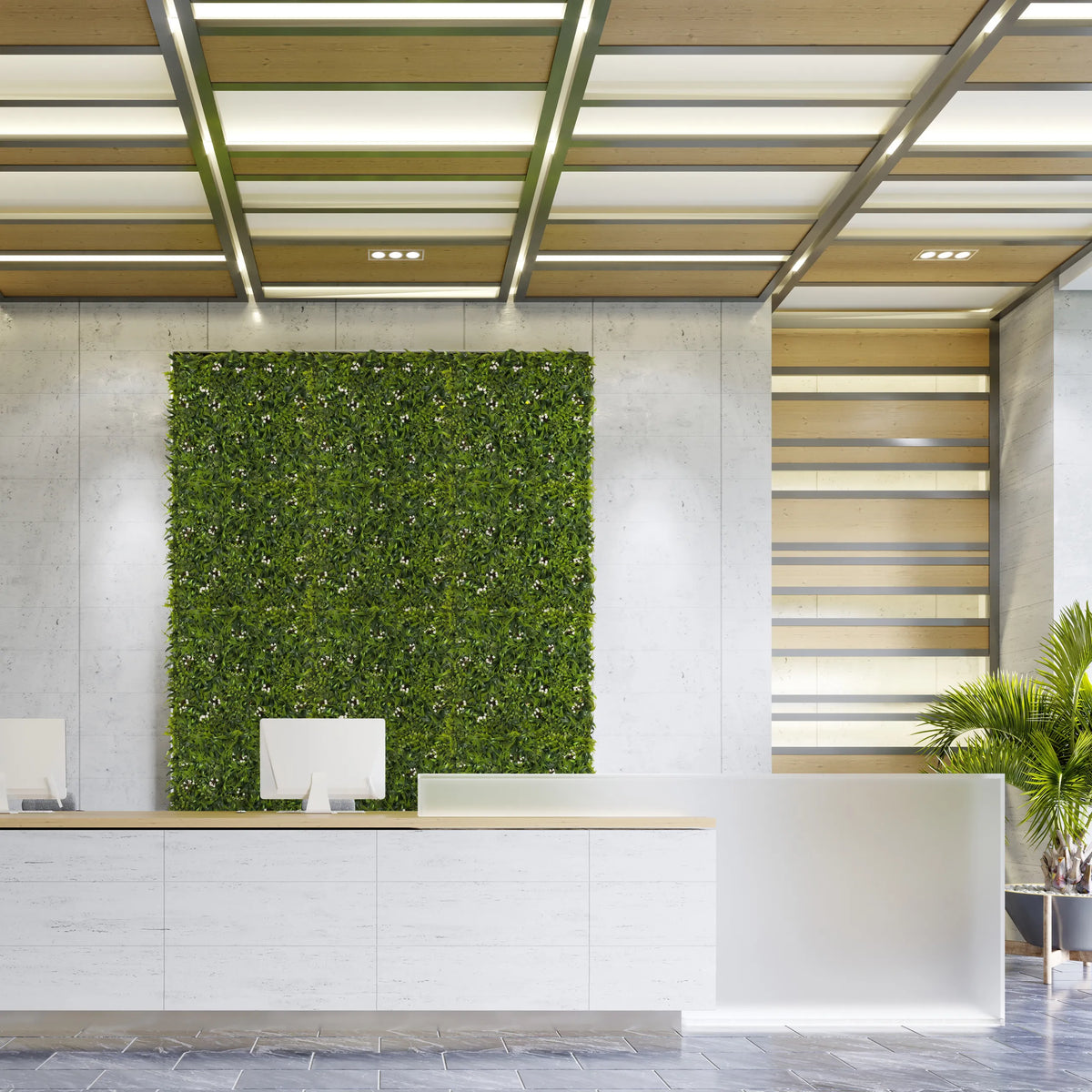 Groene plantmat MORE GREEN I als verticale beplanting op een lichte betonnen muur in een ontvangstgebied van hjh OFFICE