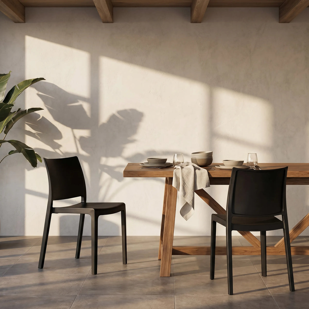 Twee zwarte Outdoor stoelen T37 V 4 aan een houten tafel in een lichte ruimte van hjh LIVING