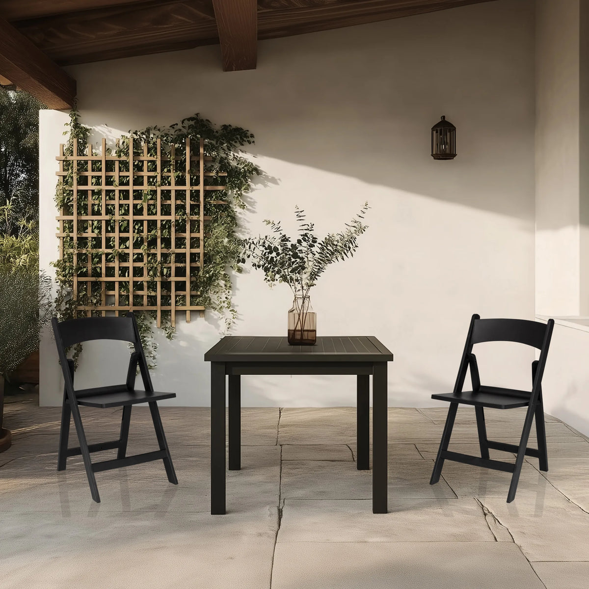Twee zwarte TRAVANO 1 outdoor stoelen met bijpassende tafel op een terras van hjh LIVING