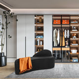 Zwarte lounge bank BARACOA met een oranje plaid voor een inbouwkast van hjh OFFICE
