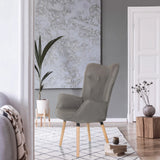 Grijze gestoffeerde fauteuil HAVENIO I met knoopdetails en vier lichte houten poten van hjh LIVING